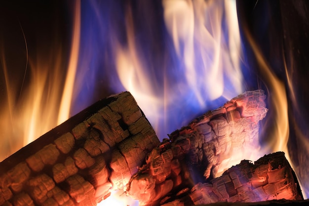 A fireplace with burning logs fire in the fireplace a cozy\
place to rest