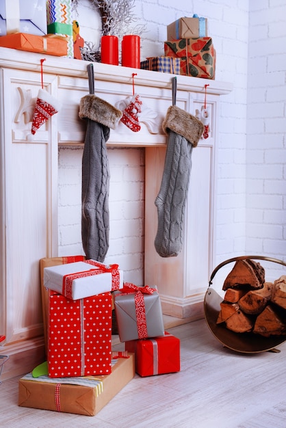 Fireplace with Christmas decoration on brick wall surface