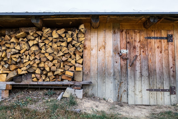 Firewood stacked near the entrance of the barn.