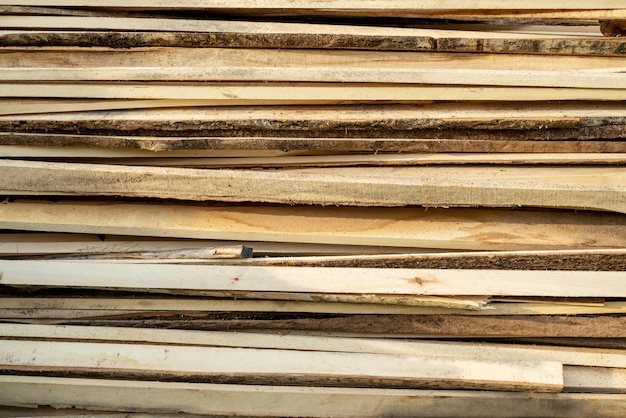 Firewood stacked neatly in a pile background and texture