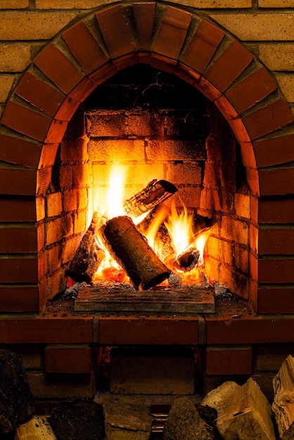 Firewood and tongues of fire in fireplace