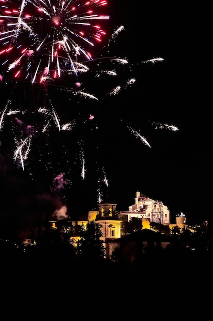 Fireworks over a castle in the night sky