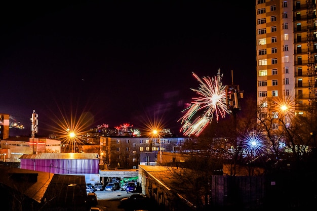 Fireworks in the night sky over the city.