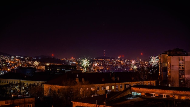 Fireworks in the night sky over the city.