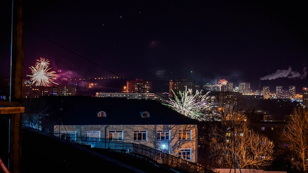 Fireworks in the night sky over the city.