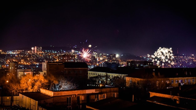 Fireworks in the night sky over the city.