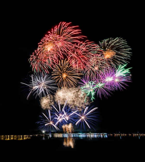 Fireworks at river, lake or ocean for new year or holiday season celebration