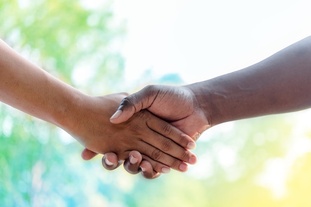 firm handshake between two colleagues outside nature 