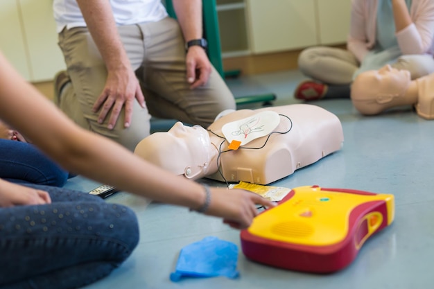 Photo first aid cardiopulmonary resuscitation course using automated external defibrillator device, aed.