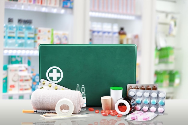 Photo first aid kit  with medical supplies on light background