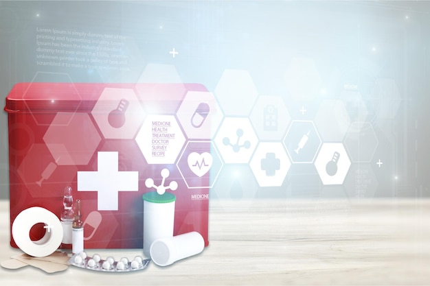 First aid kit with medicines on a wooden table with an illustration