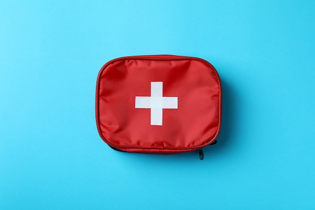 First aid medical kit on blue background