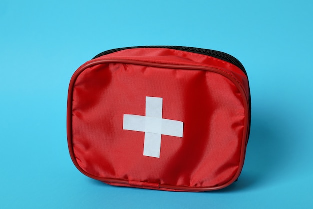 First aid medical kit on blue