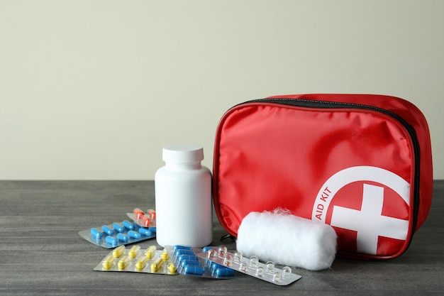 First aid medical kit on gray textured table