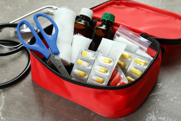 Photo first aid medical kit on gray textured