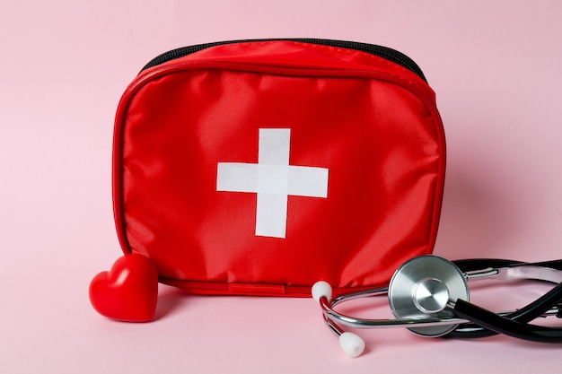 First aid medical kit on pink background