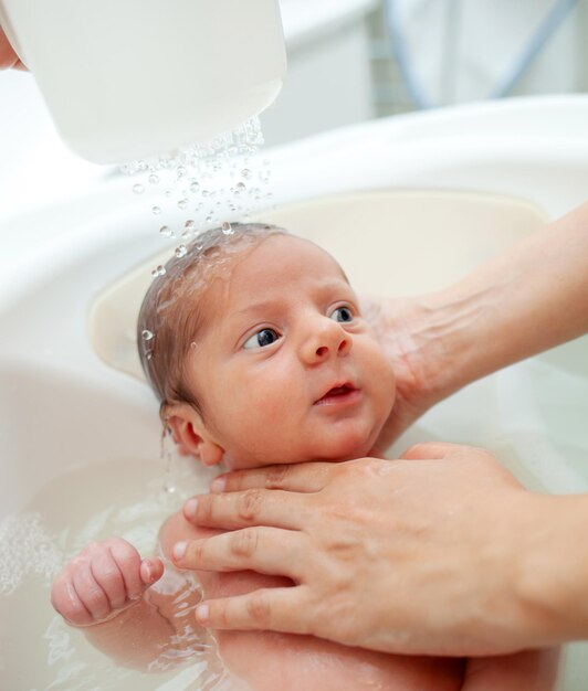 First bath of newborn baby boy