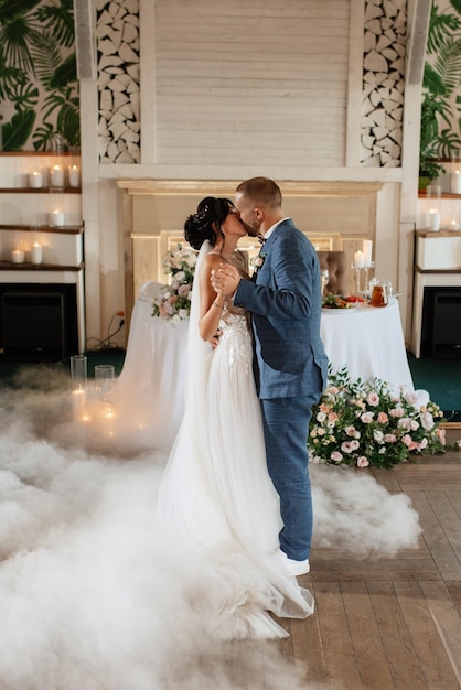 The first dance of the bride and groom inside a restauran