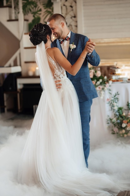 The first dance of the bride and groom inside a restauran