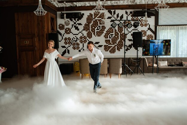 The first dance of the bride and groom inside a restaurant