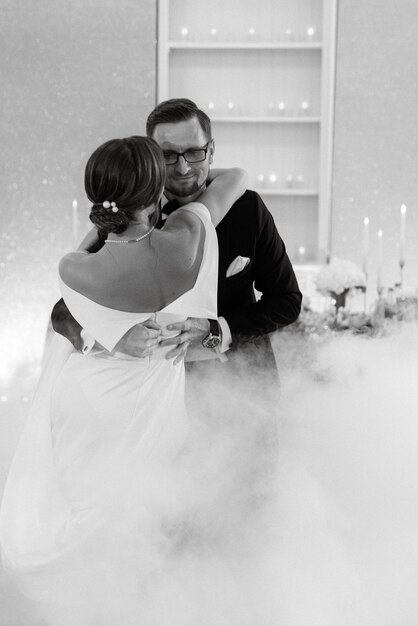 The first dance of the bride and groom inside a restaurant