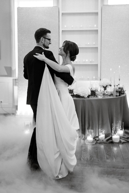 The first dance of the bride and groom inside a restaurant