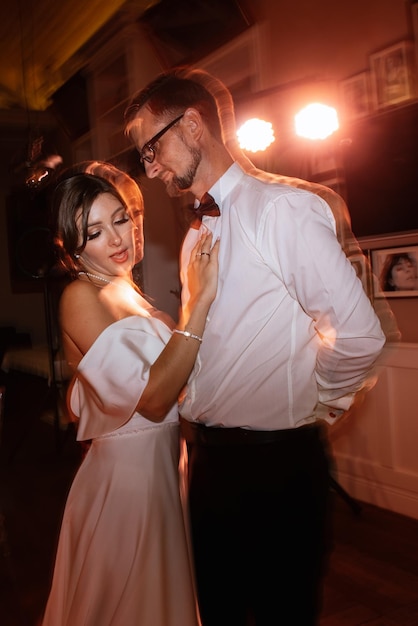 The first dance of the bride and groom inside a restaurant