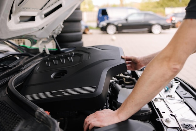 First person view of auto mechanic working in garage repair service concept