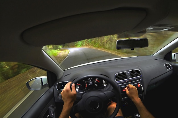 Photo first person view of a guy driving a car