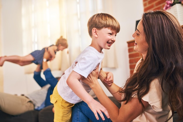 First rule of family time have lots of fun Shot of a happy young family enjoying playtime together at home