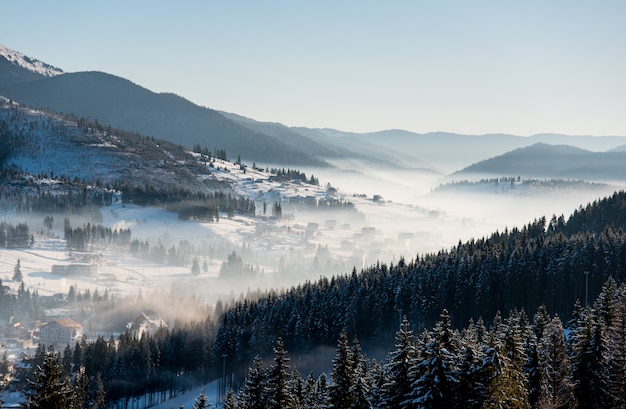 First shadows of setting sun on winter ski resort Carpathians