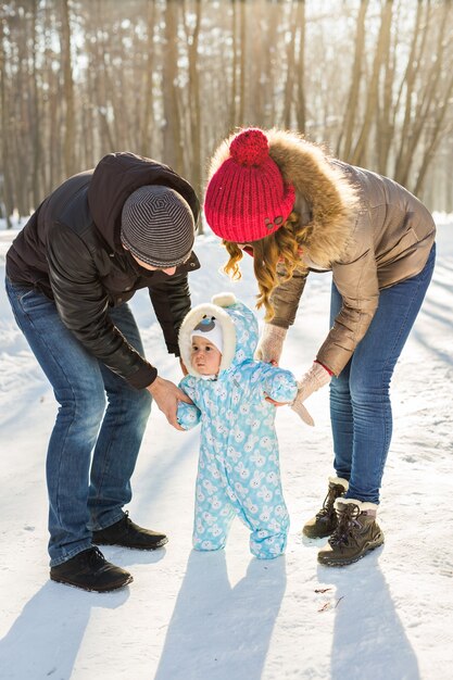 First steps of a baby in winter park.