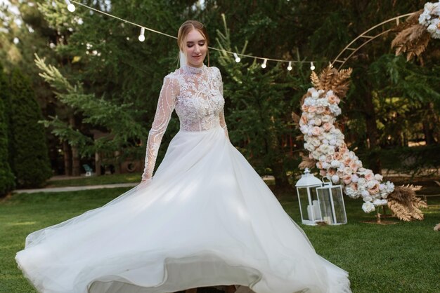 The first wedding dance of the bride and groom on a green meadow