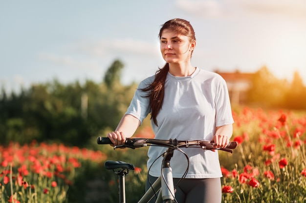 Firstperson view of handling the bicycle on the forest road in the city towards sunlight Concept of using a bicycle for sports and recreation out of a town