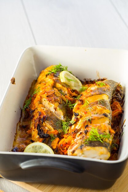 fish baked with spices and vegetables in the oven