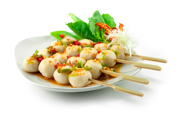 Fish Balls Grilled in Skewers with Spicy Sauce decorate vegetables sideview