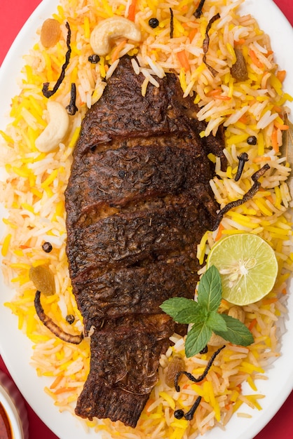 Fish Biryani or fish Rice - Popular Indian non-vegetarian recipe made of fish marinated with Indian spices fresh herbs and cooked with Basmati rice, selective focus