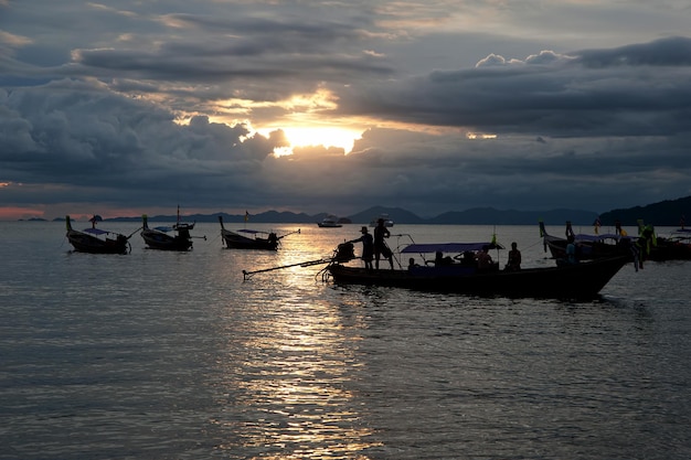 Fish boats and longboat at the sunset in Krabi Thailand