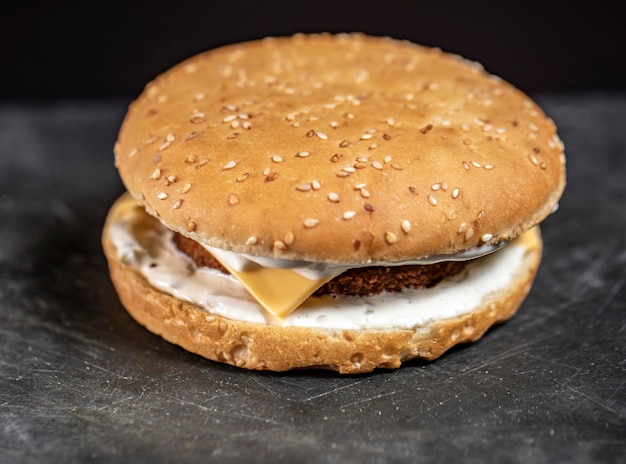 Fish burger close up on grey stone plate