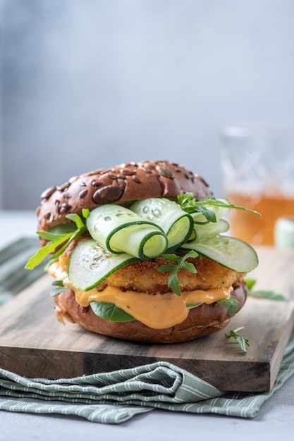 Fish burger with cucumber arugula and sauce