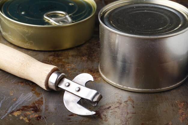 Fish can close up on wooden table with opener