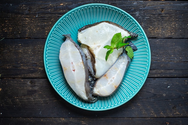 Fish catfish piece seafood steak raw product ready to cook  on the table healthy food meal