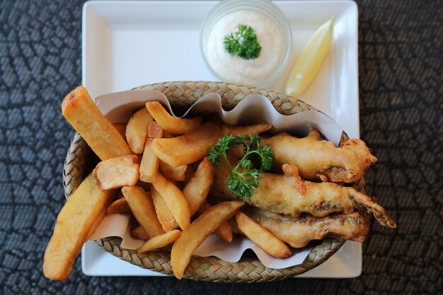 Fish and chips in close up on wood table background