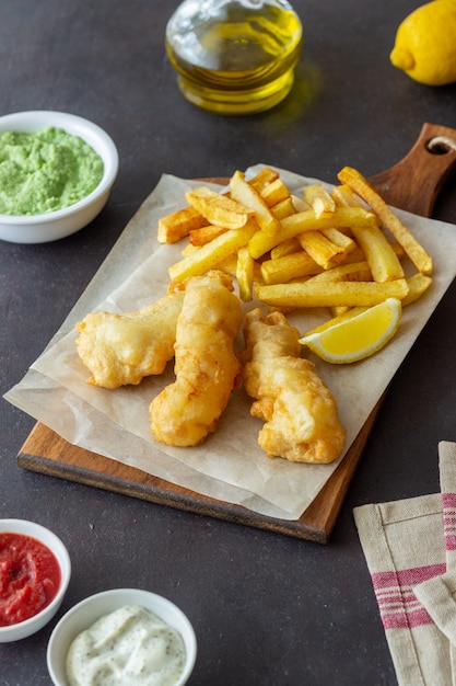 Fish and chips on a dark table. British fast food. Recipes. Snack to beer. Traditional british food.