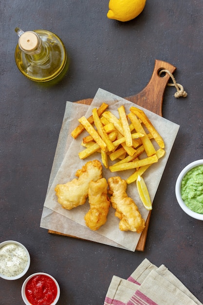 Fish and chips on a dark table. British fast food. Recipes. Snack to beer. Traditional british food.