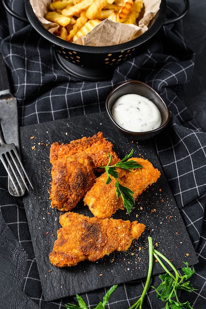 Fish and chips, French fries and cod fillet fried in breadcrumbs