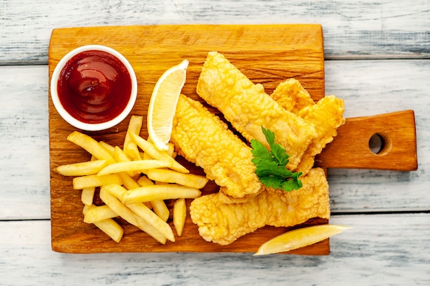 fish and chips with french fries  on wood background