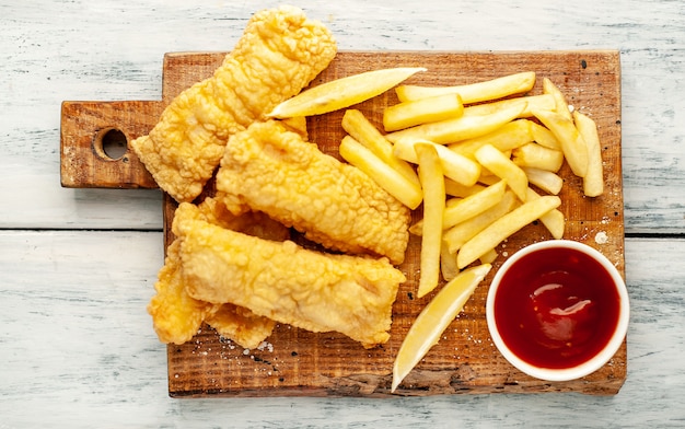 fish and chips with french fries  on wood background