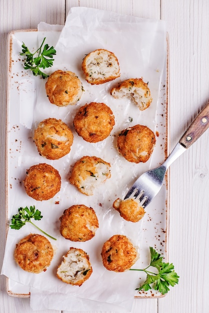 Fish croquettes on white wooden background