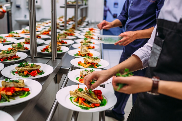 Photo fish dish with vegetables for catering. lots of plates.
